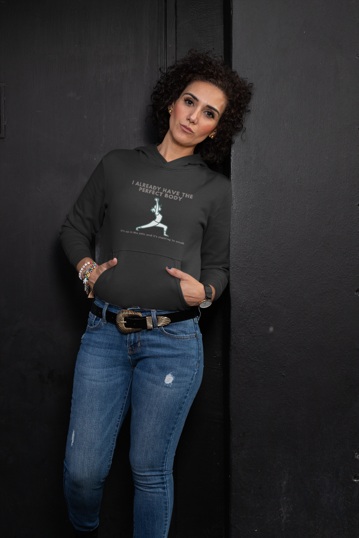 woman leans against a wall wearing a black hoodie that says I already have the perfect body it's in the attic and its starting to smell