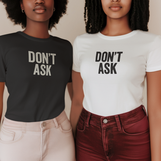 Two women wearing black and white t-shirts that say “DON’T ASK”, standing side by side.