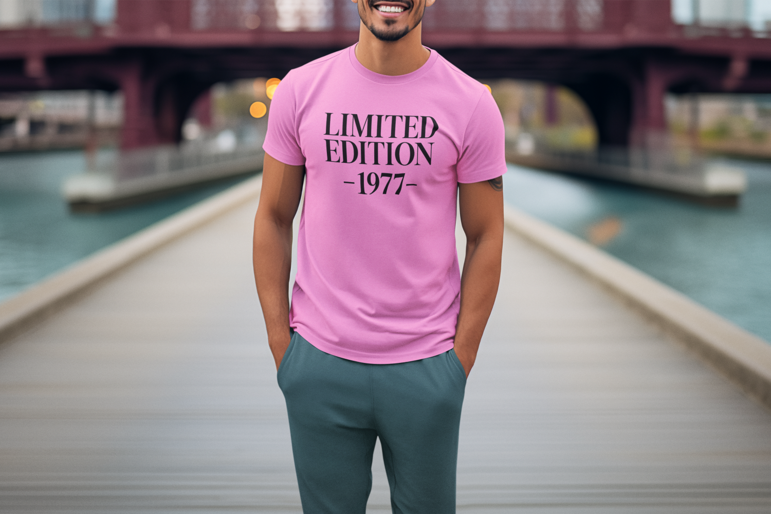 Man smiling while wearing a pink ‘Limited Edition – [Year]’ graphic t-shirt, customisable by shopper.