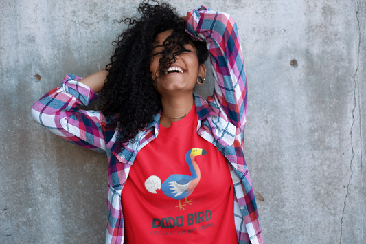 laughing woman wearing a red t shirt with a graphic of a dodo bird and the words dodo bird coolest extinct animal