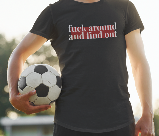 man holds a ball in a black t shirt with the words fuck around and find out